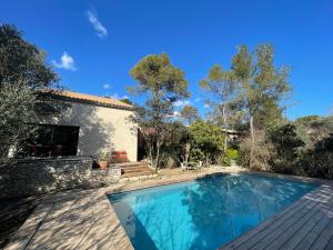 a villa with a swimming pool and a house at Oustal du pic saint loup in Saint-Jean-de-Cuculles