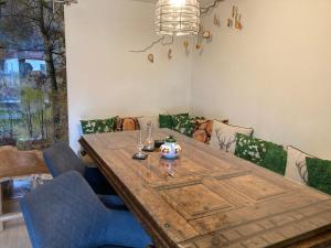 a dining room with a wooden table and chairs at Ferienhaus Gruber in Aich