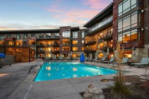 a swimming pool in front of a building at Lift Park City Condominiums by Vail Resorts in Park City