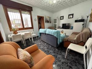 a living room with a couch and a bed and a table at LA SORIANA in Águilas