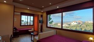 a bedroom with a large window with a view at Villa Koulouridi Agritourism in Daratso +43 photos