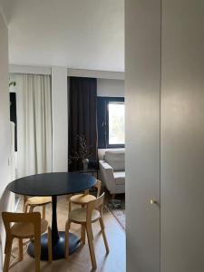 a room with a table and chairs and a couch at Cozy apartment in Parainen 