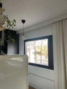 a room with a window and a curtain at Cozy apartment in Parainen 