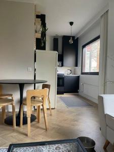 a kitchen with a table and chairs and a refrigerator at Cozy apartment in Parainen 