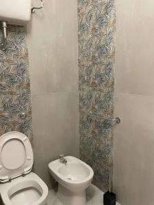 a bathroom with a toilet and a sink at Camere Lorenzo in Porto Cesareo
