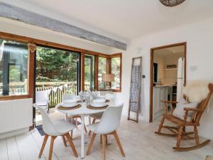 a kitchen and dining room with a table and chairs at West Island in Kingsbridge