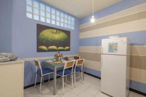 a kitchen with a table and chairs and a refrigerator at Casa Nonna in Riomaggiore +3 photos