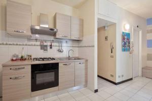 a kitchen with a sink and a stove top oven at Casa Nonna in Riomaggiore