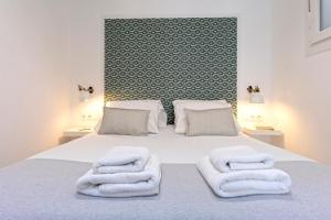 1 dormitorio con 1 cama con toallas en Livemalaga Pedregalejo, en Málaga