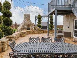 a patio with a table and chairs and a fireplace at The Hideaway in Magherafelt