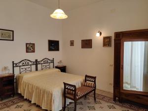 a bedroom with a bed and two chairs and a window at Casa La Bionda in Positano