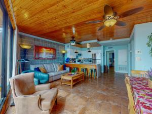 a living room with a couch and a ceiling fan at MP217 Gulf view condo with Boardwalk to Beach in Padre Island