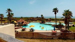 a large swimming pool with people in a resort at MP217 Gulf view condo with Boardwalk to Beach in Padre Island