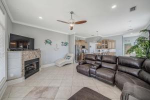 a living room with a couch and a fireplace at Deja Blue by Sand Seeker Vacations in Panama City Beach