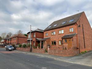 a brick house on the side of a street at Jacks Court B5 in Stalybridge