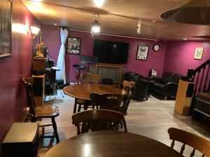 a restaurant with tables and chairs and a couch at Jacks Court B5 in Stalybridge