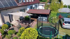 an aerial view of a house with a table and an umbrella at Pokoje gościnne Silver in Rogowo