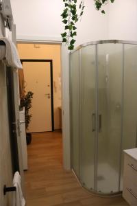 a glass shower in a room with a hallway at Triremi house in Lido di Ostia