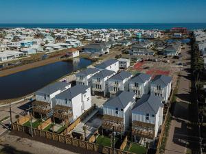 an aerial view of a city with houses and the ocean at Dorado Dunes #D Newly Built, Gorgeous Beach Home, Private Pool, Golf Cart Entire Stay in Port Aransas
