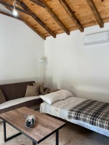 a bedroom with a bed and a coffee table at Lakeview Apartments Jolicic in Virpazar