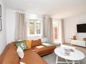 a living room with a couch and a table at Waterston Cottage in Wareham