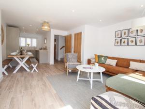 a living room with a couch and a table at Waterston Cottage in Wareham