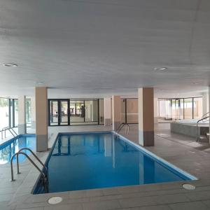a large swimming pool in a large building at LuxuryCambrils Resort&Spa in Cambrils