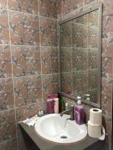 a bathroom with a sink and a mirror at KANWARA MASSAGE APARTMENT in Karon Beach