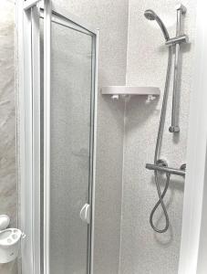 a shower with a glass door in a bathroom at The Cresswell Inn in Skegness