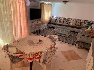 a living room with a table and a couch at Pleasant house in Africa Jade 200m to the beach in Korba