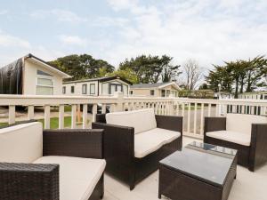 a patio with wicker chairs and a table at Eden Way 45 in Par