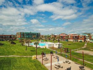 a view of a park with a pool and buildings at IR104 3BR Condo w Gulf View, Shared Pools, Boardwalk in Port Aransas