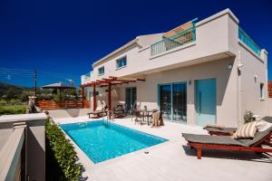 a villa with a swimming pool and a house at Melior Holiday Houses in Laganas