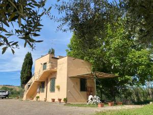 una pequeña casa con un árbol delante en Adamasseria Case Vacanza, en Collecorvino