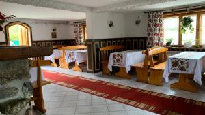 a restaurant with tables and chairs in a room at Stary Bór in Murzasichle