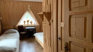 a room with two beds and a window at Stary Bór in Murzasichle