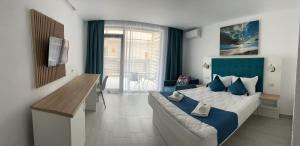 a bedroom with a large bed with a blue headboard at Complex Sea Star 2Mai in 2 Mai +47 photos