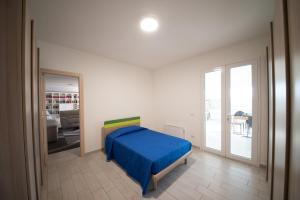 a bedroom with a bed with a blue blanket at 10 e Lode in Mazara del Vallo +67 photos
