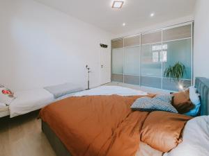 a bedroom with two beds and a large window at Priestranný apartmán v centre in Košice +11 photos