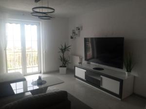 a living room with a large flat screen tv at NATALIJA - holiday house with garage in Sveti Juraj