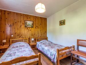 two beds in a room with wooden walls at Appartement La Clusaz, 3 pièces, 6 personnes - FR-1-437-10 in La Clusaz