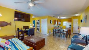 a living room with a couch and a dining room at SIV10 Beautiful Condo, Shared Pool, Close to Beach in Port Aransas