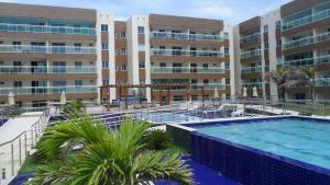 a large swimming pool in front of a building at VG Fun Residence Praia do Futuro in Fortaleza
