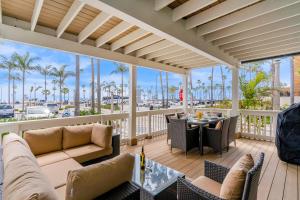 a patio with furniture and a view of the ocean at Palm Tree Oasis in Newport Beach