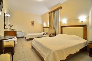 Postel nebo postele na pokoji v ubytování Filoxenia Hotel
