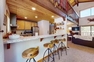 a kitchen and living room with a counter and stools at Beaver Lodge in South Lake Tahoe