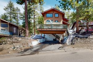 a large house with a balcony in the woods at Beaver Lodge in South Lake Tahoe