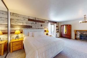 a bedroom with a bed and two lamps and a fireplace at Beaver Lodge in South Lake Tahoe