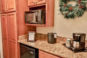 a kitchen with a counter top with a microwave at The Inn at Christmas Place in Pigeon Forge