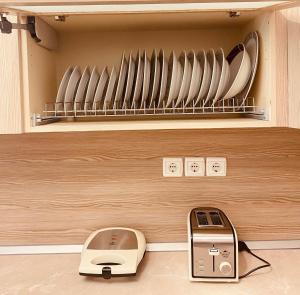 a kitchen with a toaster and a scale and plates at Port Sea View in Skiathos